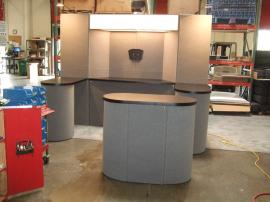 Modified FF-110 Intro Fabric Folding Panel System with Storage, Monitor Mount, Oval Counter, and Backlit Alcove Header -- Image 1