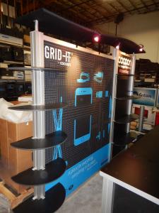 RENTAL: Modified RE-1010 with Custom Rectangular Counter, Custom Black Laminated Shelves, Halogen Arm Lights, Tension Fabric Graphics, and Sintra Infill Graphics for Counters -- Image 2