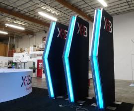 (3) Double-sided Towers with SEG Fabric Graphics, Printed Wings, and LED RGB Lighting and (1) Aero Overhead Hanging Sign (15' Dia. x 4' H) -- View 2