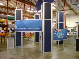 20' x 20' Visionary Designs Island Exhibit -- MODUL Extrusion, Tension Fabric Headers, and Backlit Counters