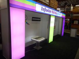 RENTAL: Custom Design with Backlit Header and Columns, Tension Fabric Backwall, RE-703 Charging Station, RE-1566 Backlit Reception Counter, and Direct Print Stand-Off Graphics