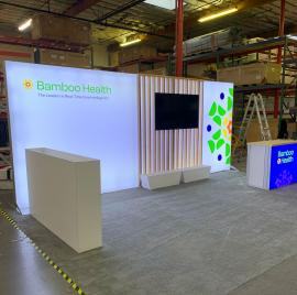 RENTAL: Inline Design with Single-Sided Lightbox, Large White Laminated Planter Box, and (2) Small Planter Boxes, RE-1567 Backlit Reception Counter with Hard Rock Maple Top, Custom Slatted Wood, Large Monitor Mount, 65" Monitor, and SEG Fabric Graphics --