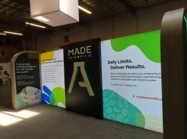 Custom Reconfigurable Inline/Island with Backlit Graphics, Edgelit LED Accents, Halolit Logo, MOD-5100 Reception Counter with Locking Storage, and MOD-1482 Charging Table with Wireless Charging Pads