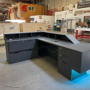 Custom Office Reception Counter with a Backlit Logo, LED Accent Lights, Shelves, Drawers, and Locking Storage -- View 4