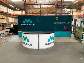 RENTAL: Conference Storage Room @ 230" Wide x 114" Deep x 95" High, with Locking Doors, White PVC Inserts for Interior Conference Room Walls, Large Monitor Mount, RE-1235 Half Circle Reception Counter/Bar with Black Laminated Tops, Interior Shelves, and L