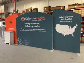 Customized 10 x 20 Symphony Portable Display with SEG Fabric Graphics, Monitor Mount, SYM-407B Backwall Counter with Locking Storage, and MOD-1703 Reception Counter with Backlit Graphics -- View 3