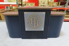 Custom Wood Fabrication Inline Exhibit with (1) Center Arch, (2) Side Arches, Shelves, Locking Backwall Cabinets, Fabric Graphics, and Custom Reception Counter with Locking Storage -- View 3