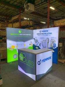 RENTAL: (2) RE-1043 Single-Sided Lightboxes Attached in L-Shape Configuration, RE-1572 L-Shaped Backlit Reception Counter, SEG Backlit Fabric Graphics