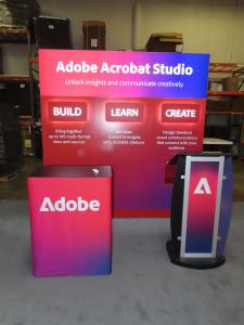 Custom Exhibit with LED Halo and Backlit Lights, SuperNova Header Lightbox, Lighting Remote, SYM-416 Counter with Fabric Graphics, and MOD-1549 Lectern with Graphics