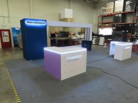 Custom Inline with Gravitee Closet, SEG Graphics, Archway Support for LED Video Tiles, Locking Cabinet, and (2) Custom L-shaped Counters with Halo Lit Logo Signs