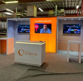 RENTAL: Modified RE-2135 Inline Design with Gravitee Panel System Backwall with Storage Closet, (1) 76" W x 95" H Single-Sided Lightbox with Fabric Blocker Panel, (2) White Laminated Ceiling Soffits with Recessed Puck Lights, RE-1576 White Laminated Recep